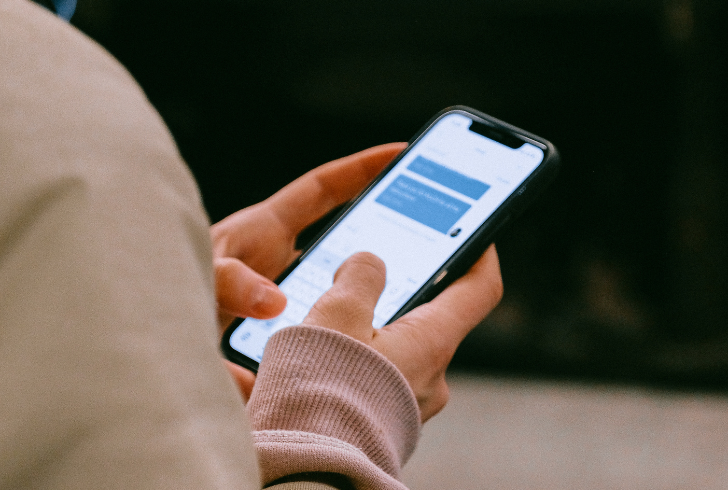 Person sending message on phone